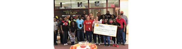 Large check donated by DFW Metro branch to a local middle school